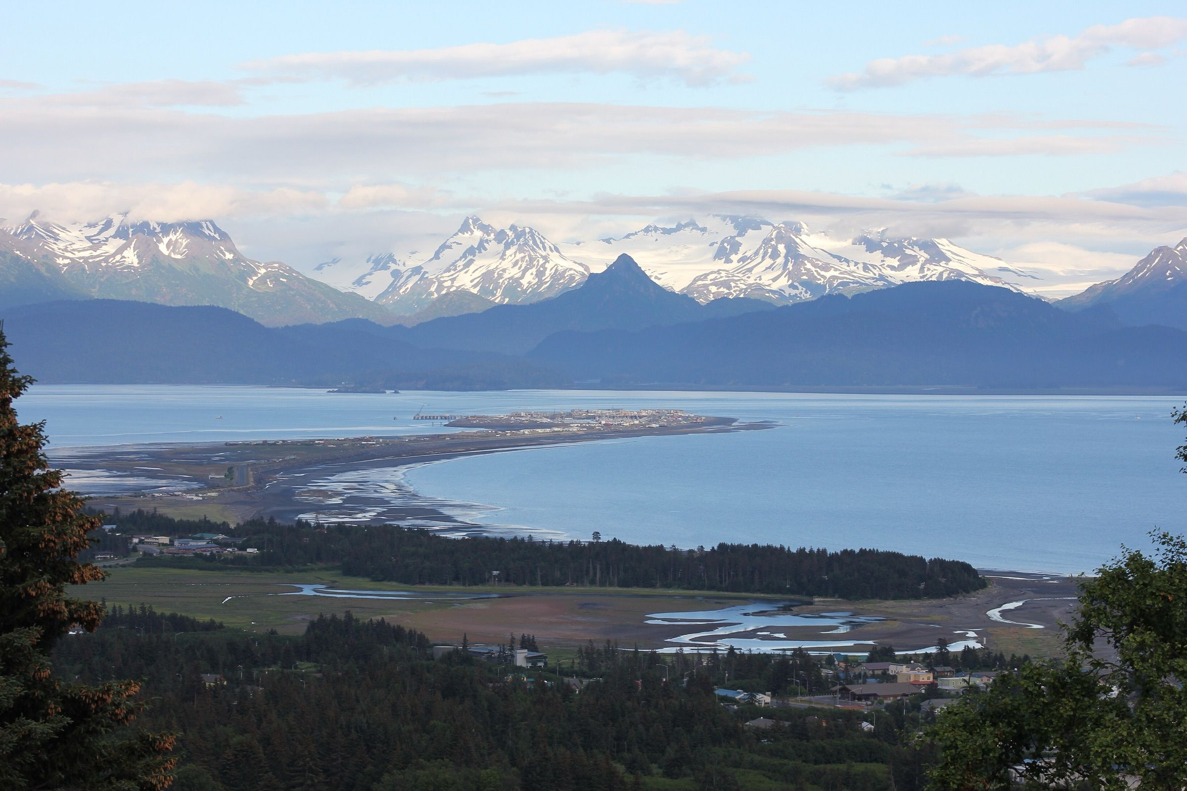 Homer Spit reaching into the bay below snow-capped mountains