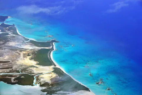 Aerial view of Shroud Cay's mangrove creeks and pale sand flats meeting turquoise shallows in the Exuma Cays