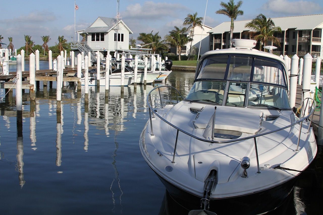 A cabin cruiser in its slip at a palm-lined resort marina on Captiva Island