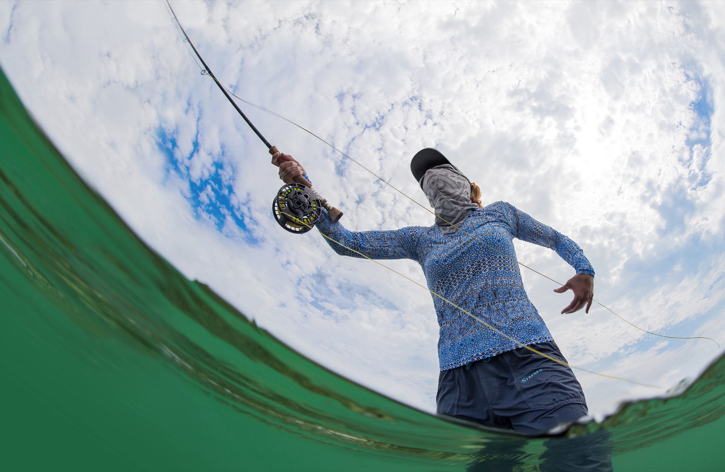 Low-angle view from the water of an angler fly casting on the shallow flats of the Florida Keys National Marine Sanctuary