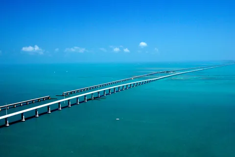 Aerial view of the Seven Mile Bridge running west of Marathon beside the old Flagler railroad bridge over turquoise water