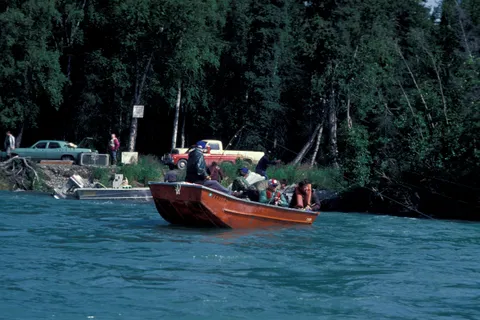 Anglers fishing from a small boat on the Kenai River