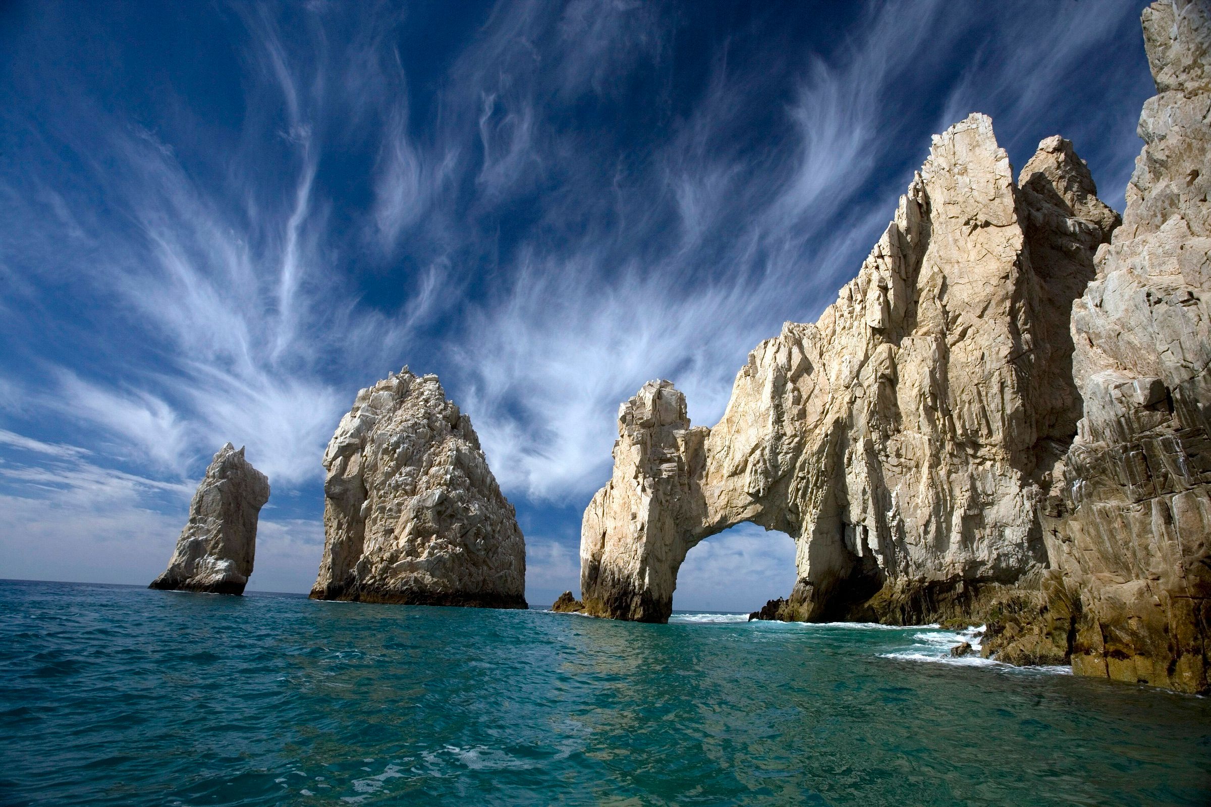 El Arco and nearby sea stacks at Cabo San Lucas under a streaked sky