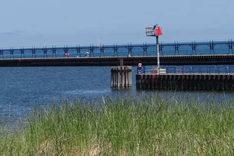 Manistee North Pierhead Lighthouse and breakwater at the mouth of the Manistee River on Lake Michigan