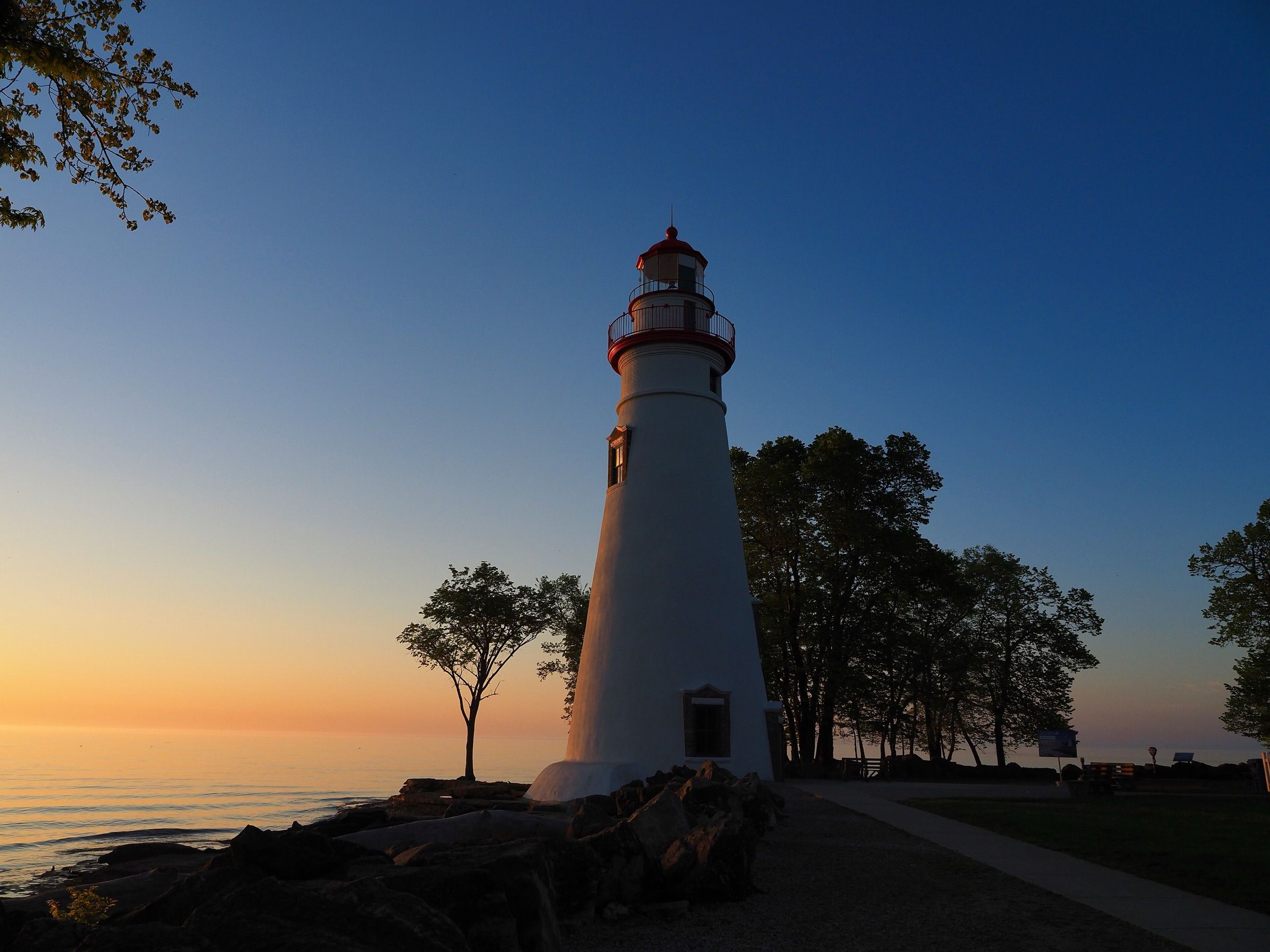 Marblehead Lighthouse at sunrise above the rocky Lake Erie shore