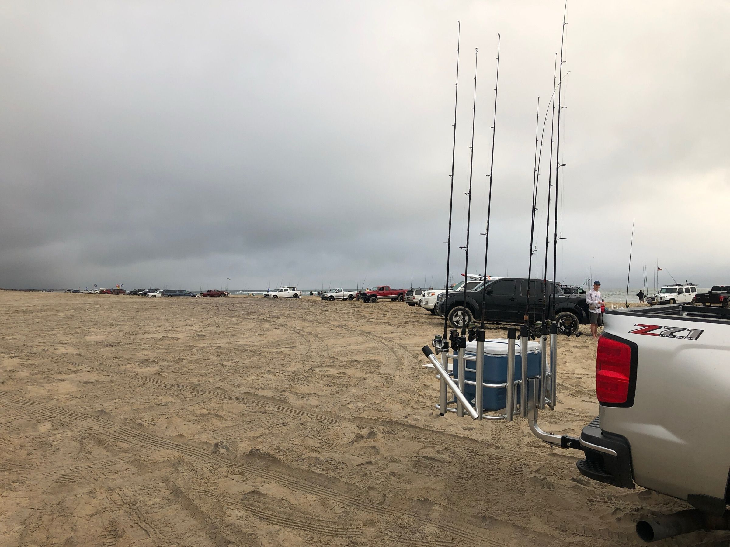 Surf rods standing in a truck-mounted rod rack on the beach at Cape Point as anglers line up their trucks in October