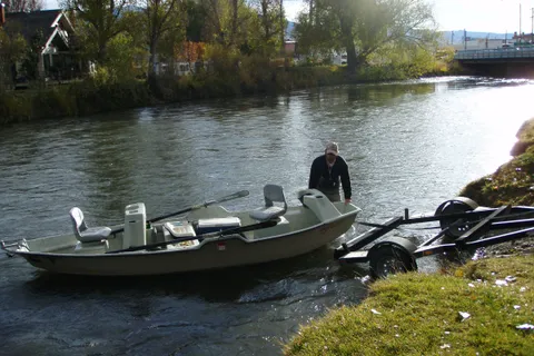 Angler launching a drift boat on the Beaverhead River at Twin Bridges