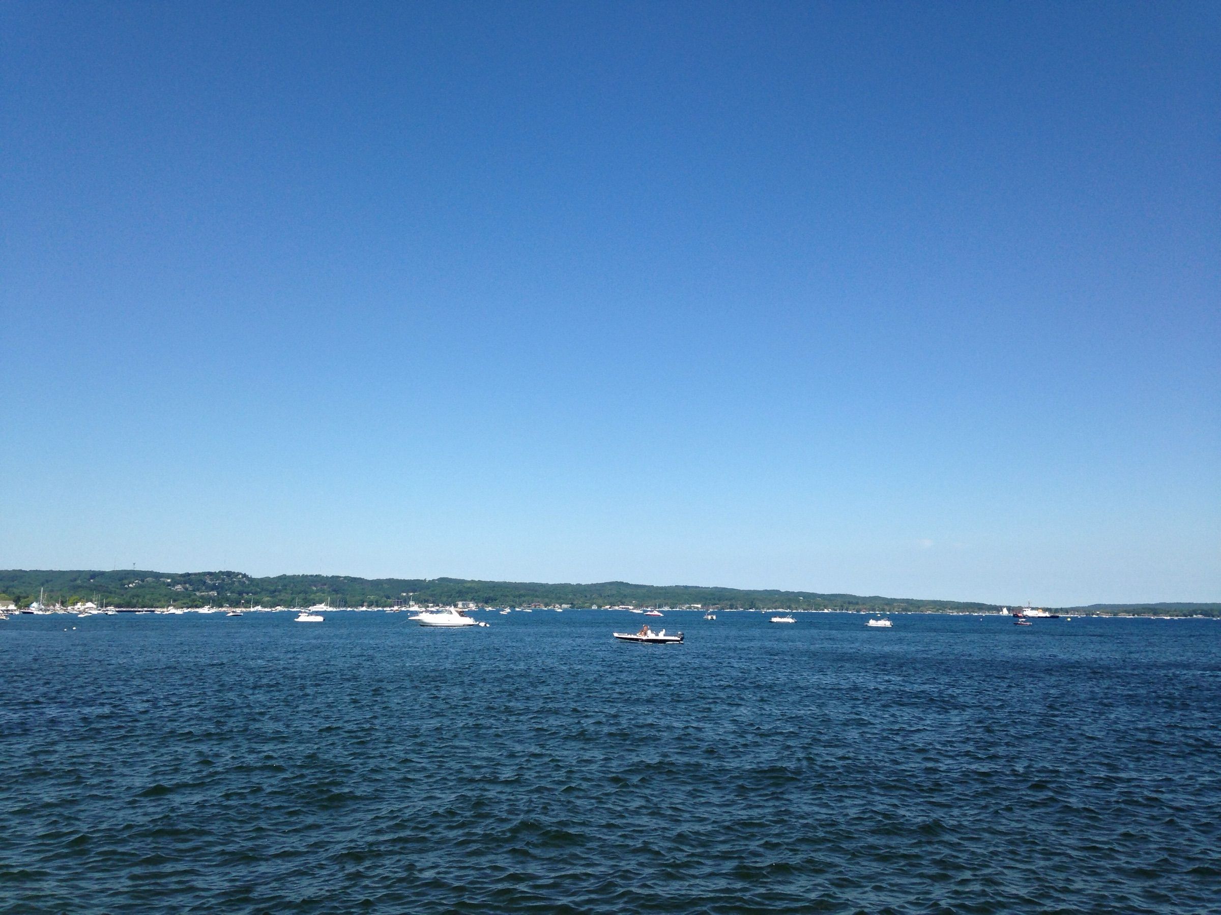 Boats anchored on deep blue West Grand Traverse Bay off Traverse City on a clear summer day