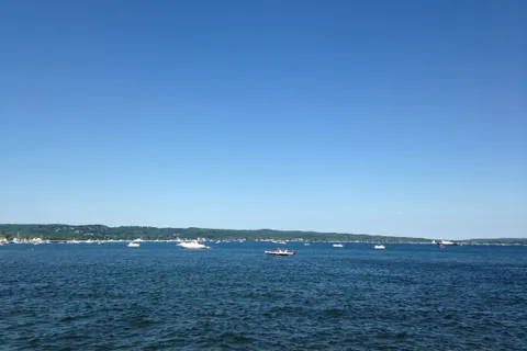 Boats anchored on deep blue West Grand Traverse Bay off Traverse City on a clear summer day